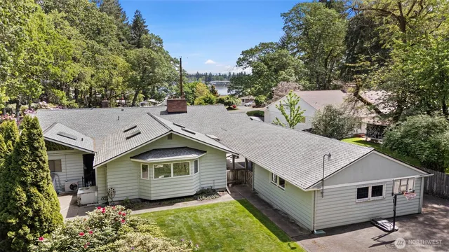 a aerial view of house with yard and trees in the background
