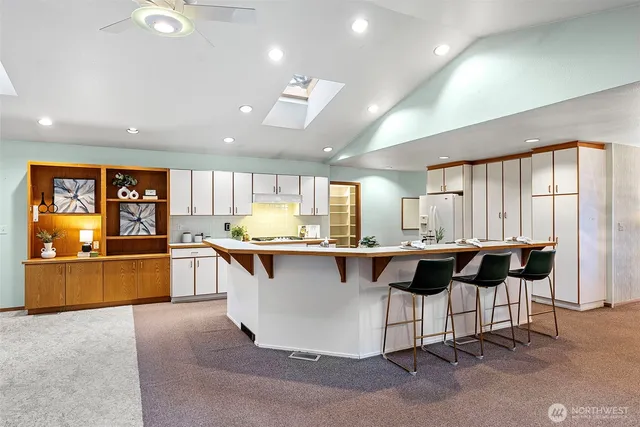 a kitchen with a counter top space a sink stainless steel appliances and cabinets