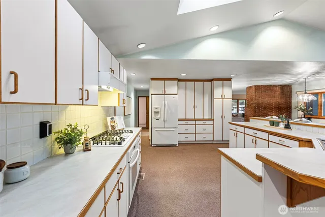 a kitchen with a sink stove and refrigerator