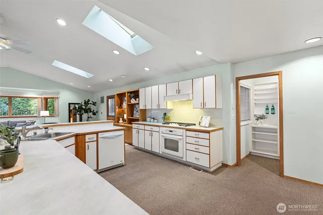 a kitchen with stainless steel appliances kitchen island hardwood floor sink and stove