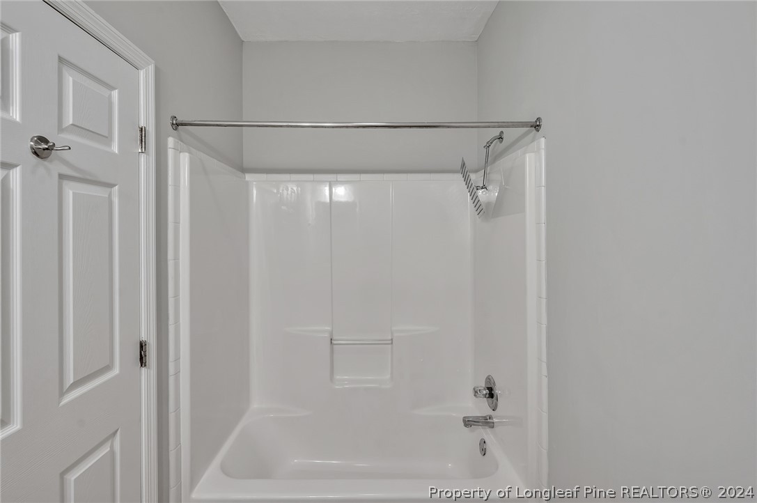 3713 Glenn Road Parkton, NC 28371 - Photo 16 of 17 a bathroom with a glass shower door