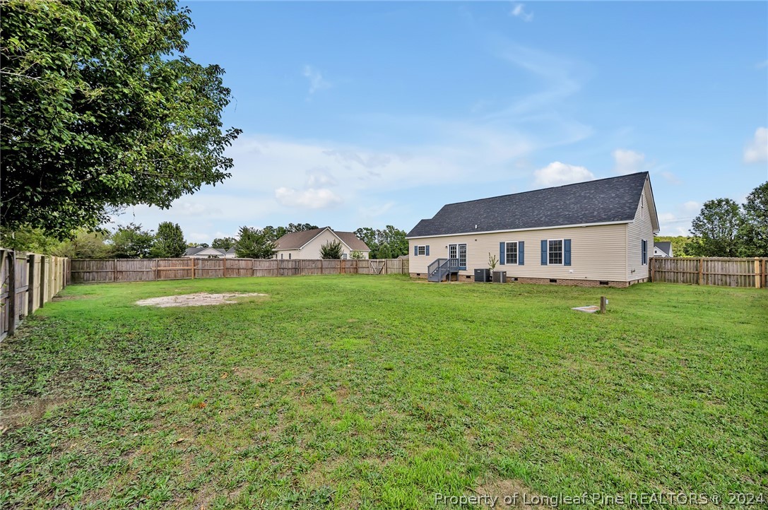3713 Glenn Road Parkton, NC 28371 - Photo 17 of 17 a view of a house with backyard and garden