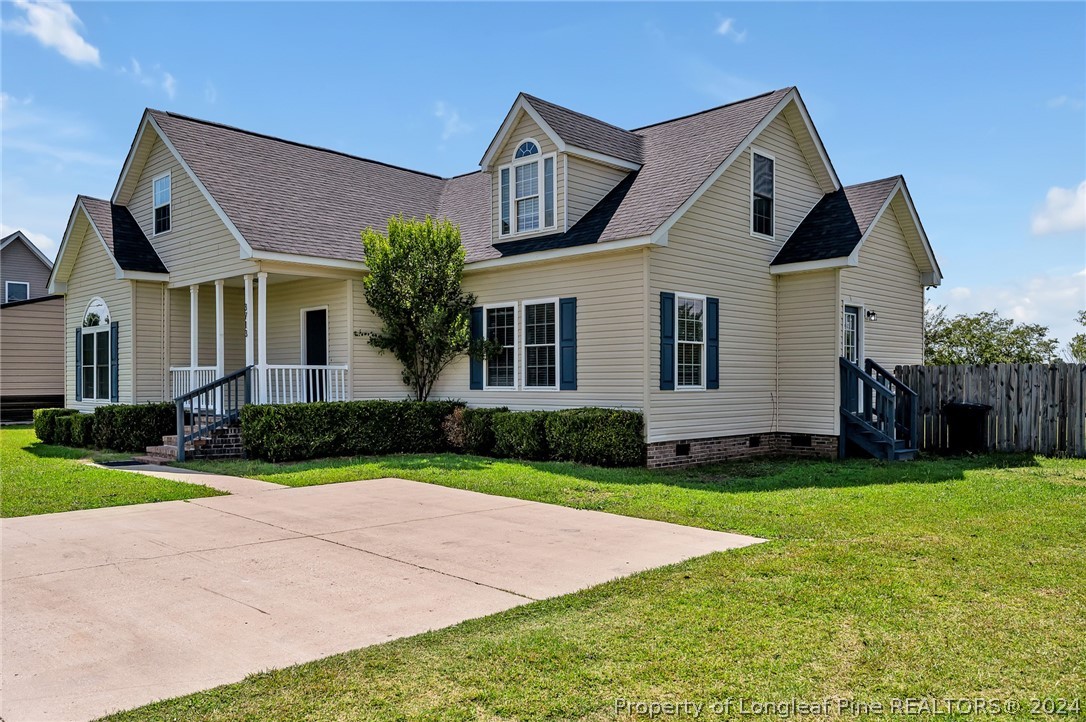 3713 Glenn Road Parkton, NC 28371 - Photo 2 of 17 a front view of a house with a yard and garage