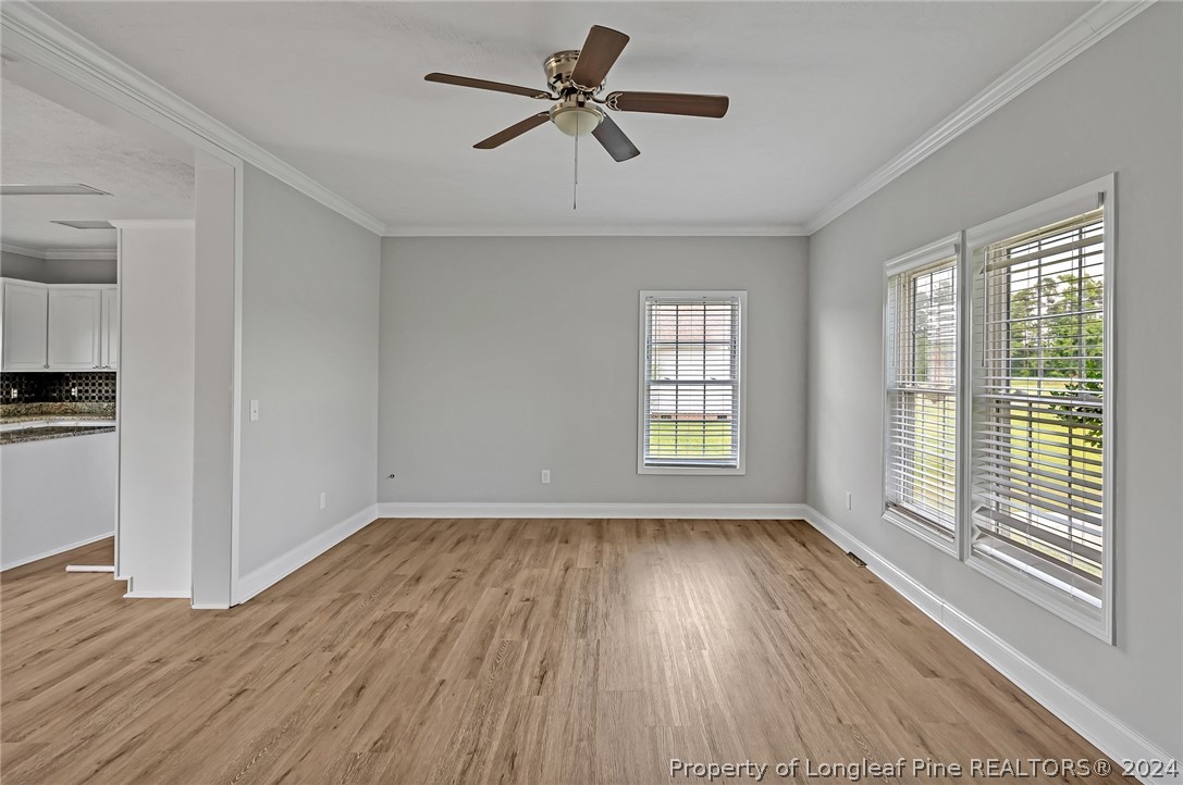 3713 Glenn Road Parkton, NC 28371 - Photo 6 of 17 a view of empty room with wooden floor and fan