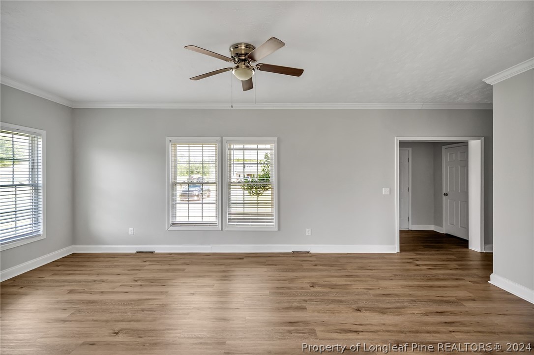 3713 Glenn Road Parkton, NC 28371 - Photo 7 of 17 a view of an empty room with wooden floor and a window