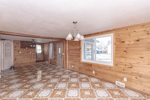 a room with wooden floor and white walls
