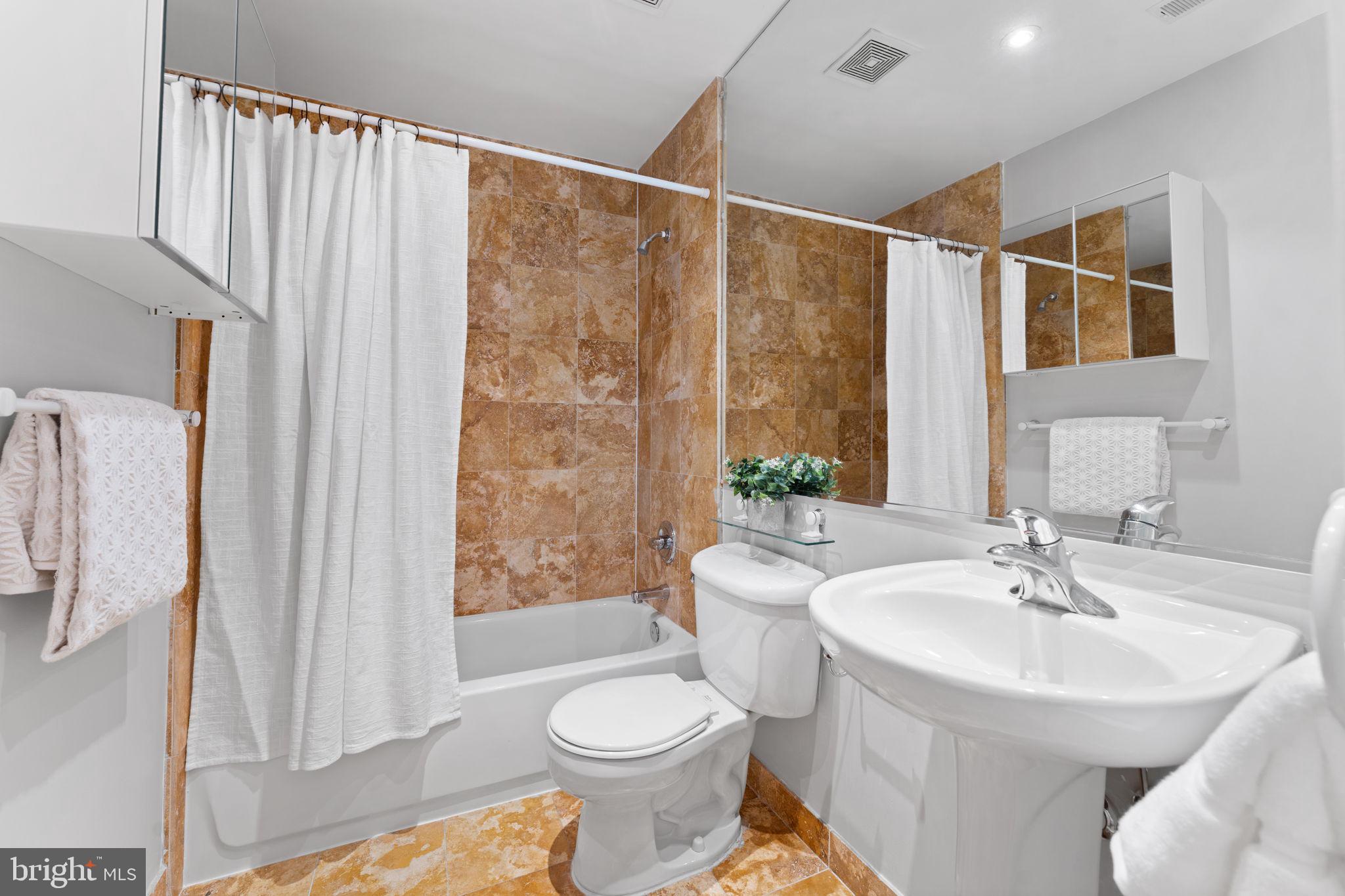 1300 13th Street Northwest, Unit 603 Washington, DC 20005 - Photo 11 of 26 a bathroom with a sink toilet and shower