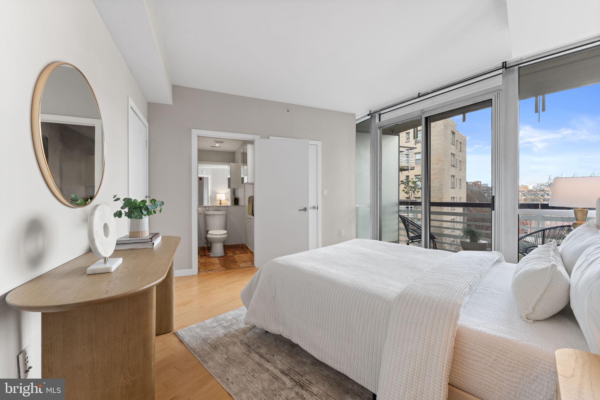 1300 13th Street Northwest, Unit 603 Washington, DC 20005 - Photo 12 of 26 a bedroom with a large bed and a mirror