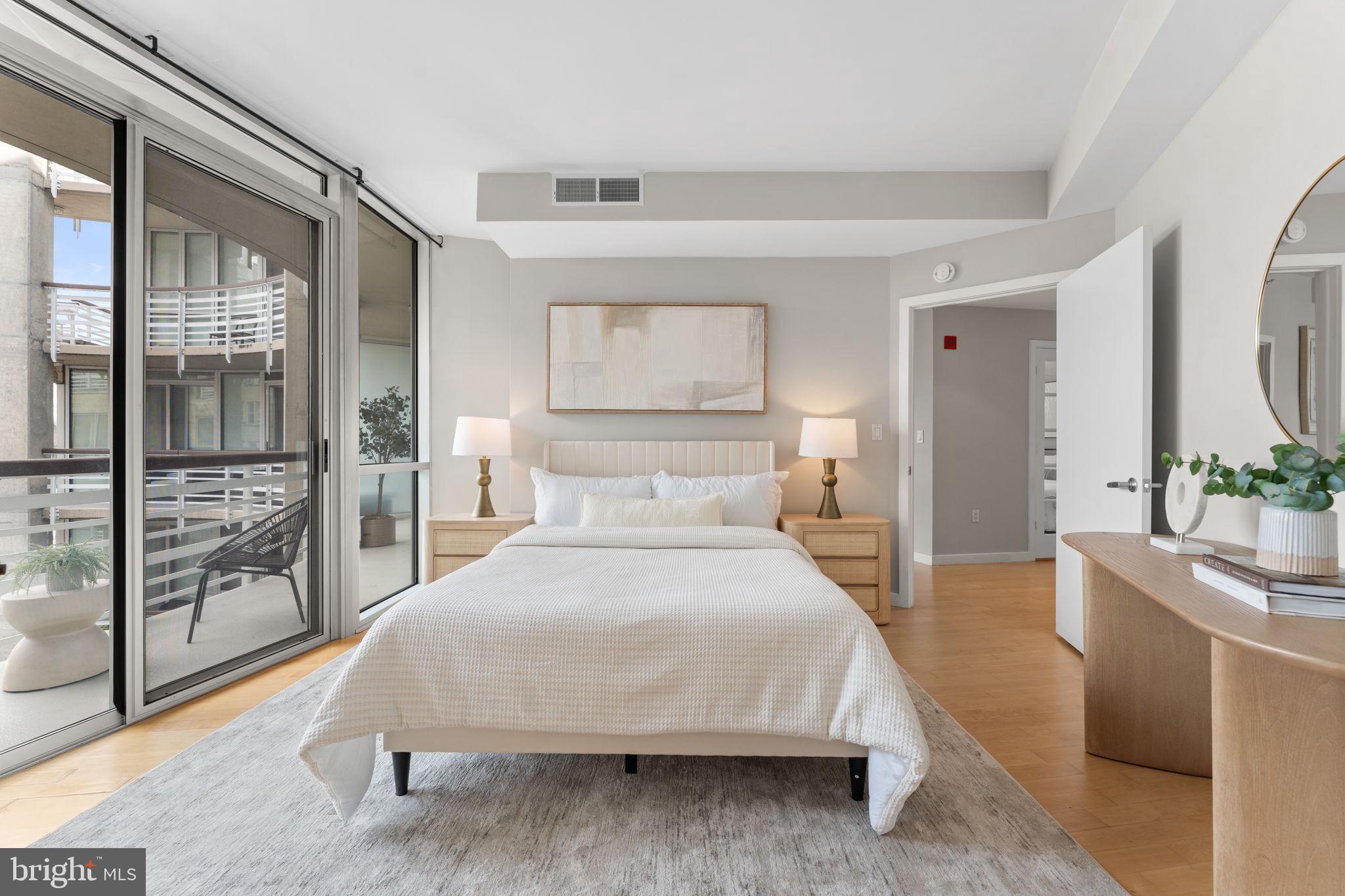 1300 13th Street Northwest, Unit 603 Washington, DC 20005 - Photo 13 of 26 a bedroom with a large bed and a large window