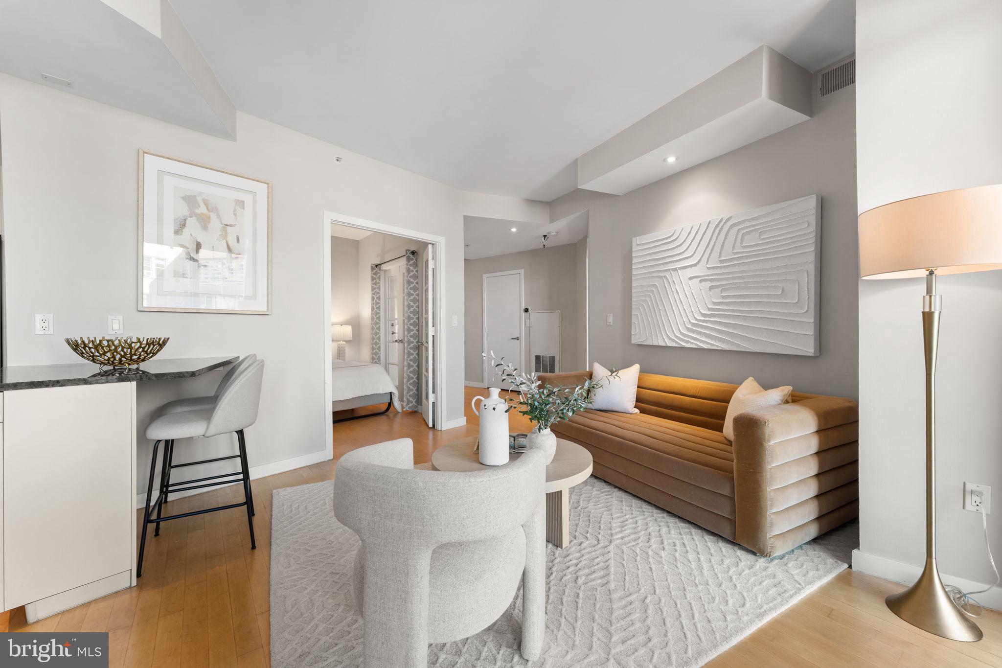 1300 13th Street Northwest, Unit 603 Washington, DC 20005 - Photo 5 of 26 a living room with furniture a rug and a lamp