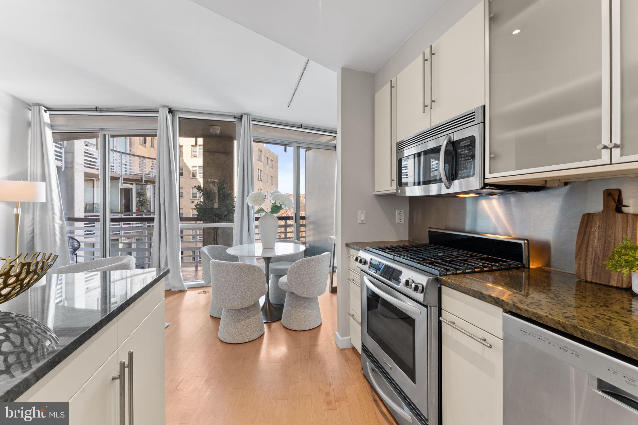 1300 13th Street Northwest, Unit 603 Washington, DC 20005 - Photo 7 of 26 a kitchen with a stove a sink and cabinets