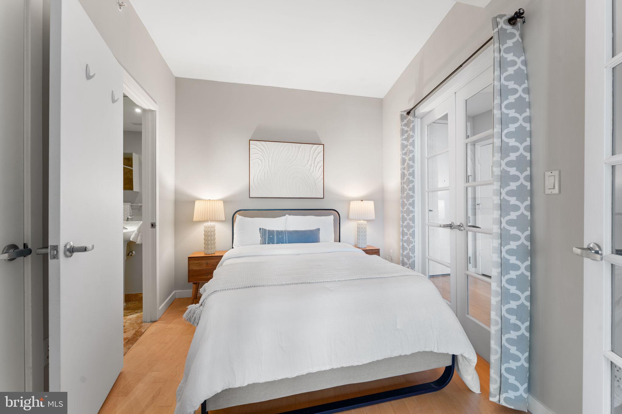 1300 13th Street Northwest, Unit 603 Washington, DC 20005 - Photo 9 of 26 a bedroom with a bed and a window