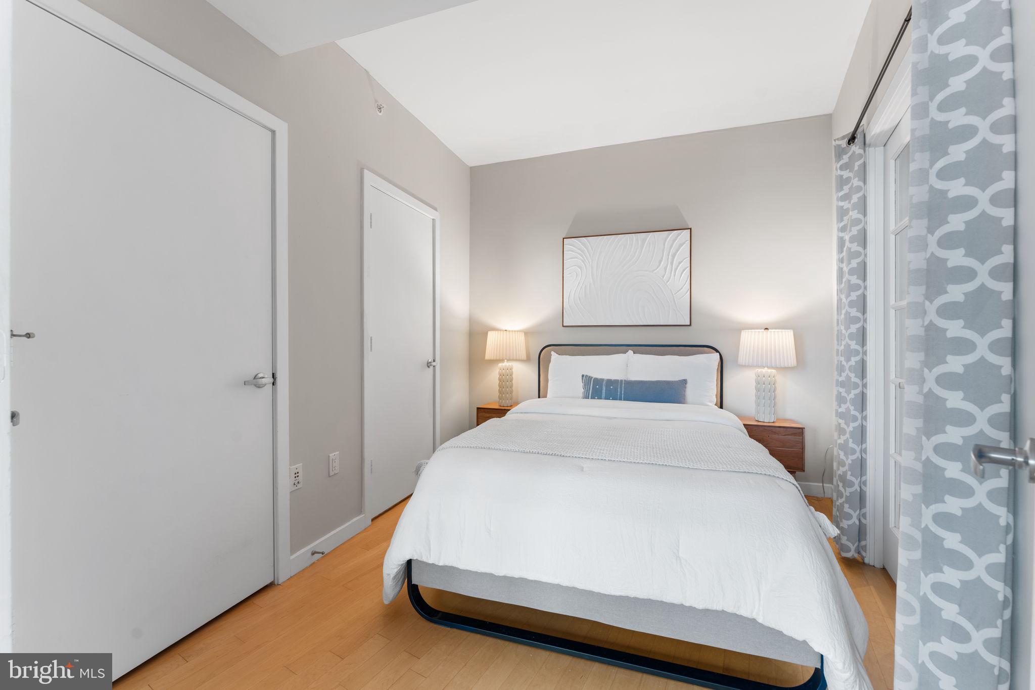 1300 13th Street Northwest, Unit 603 Washington, DC 20005 - Photo 10 of 26 a bed room with a bed and a night lamp