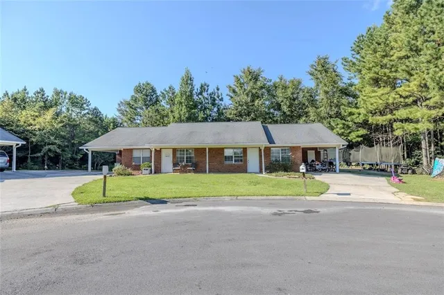 a view of house with outdoor space and trees