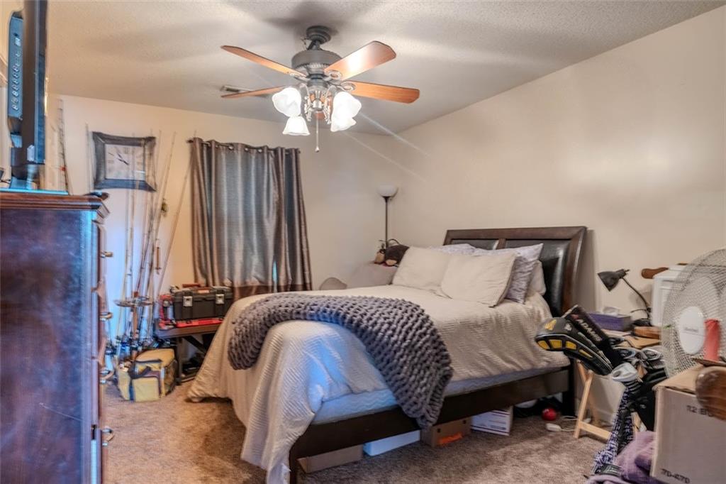 15 Oakcrest Trail Northeast Rome, GA 30165 - Photo 7 of 22 a spacious bedroom with a bed and a chandelier