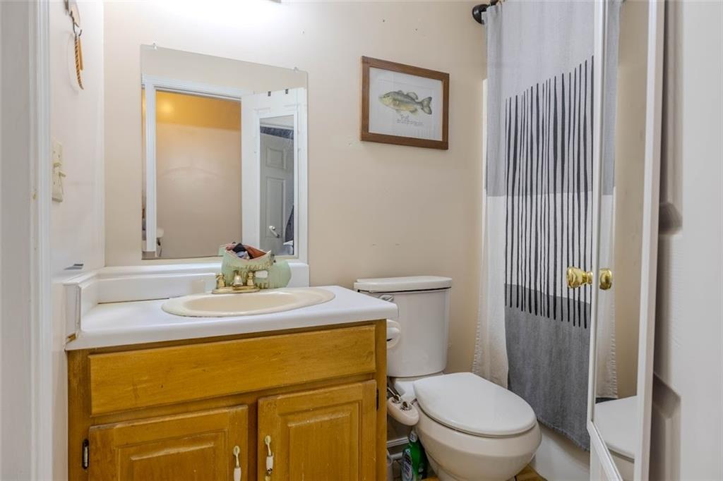 15 Oakcrest Trail Northeast Rome, GA 30165 - Photo 9 of 22 a bathroom with a granite countertop toilet sink and mirror