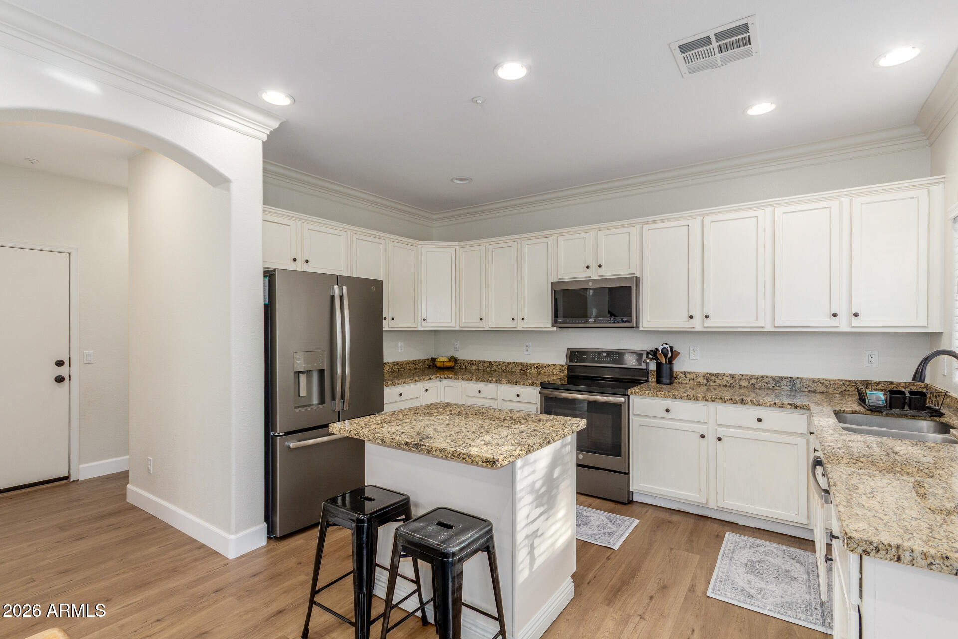1519 East Elgin Street Gilbert, AZ 85295 - Photo 11 of 36 a kitchen with a refrigerator a stove top oven a sink and cabinets