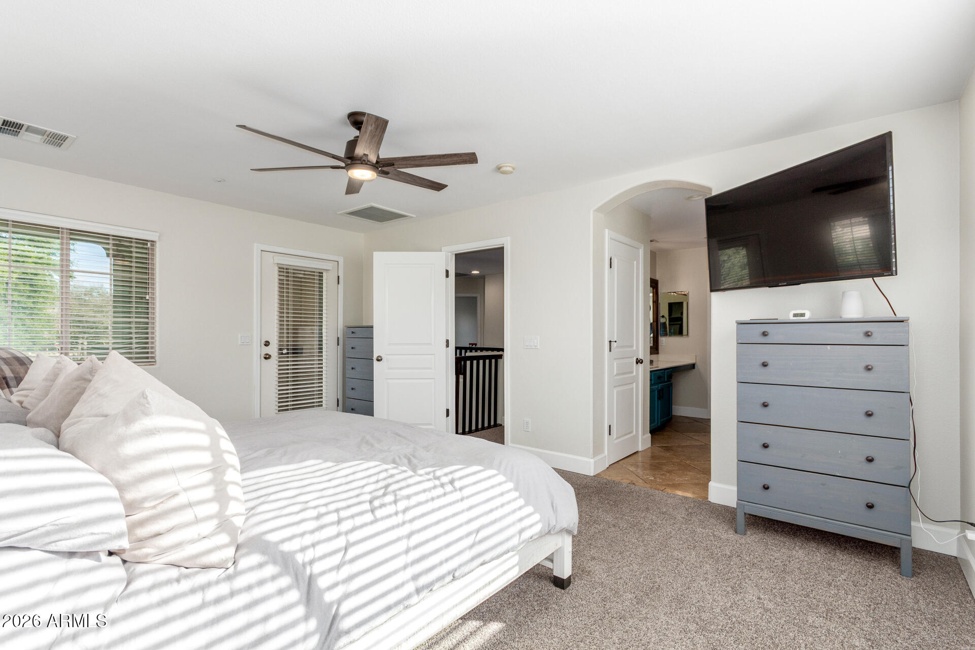 1519 East Elgin Street Gilbert, AZ 85295 - Photo 16 of 36 a bedroom with a bed and a flat screen tv