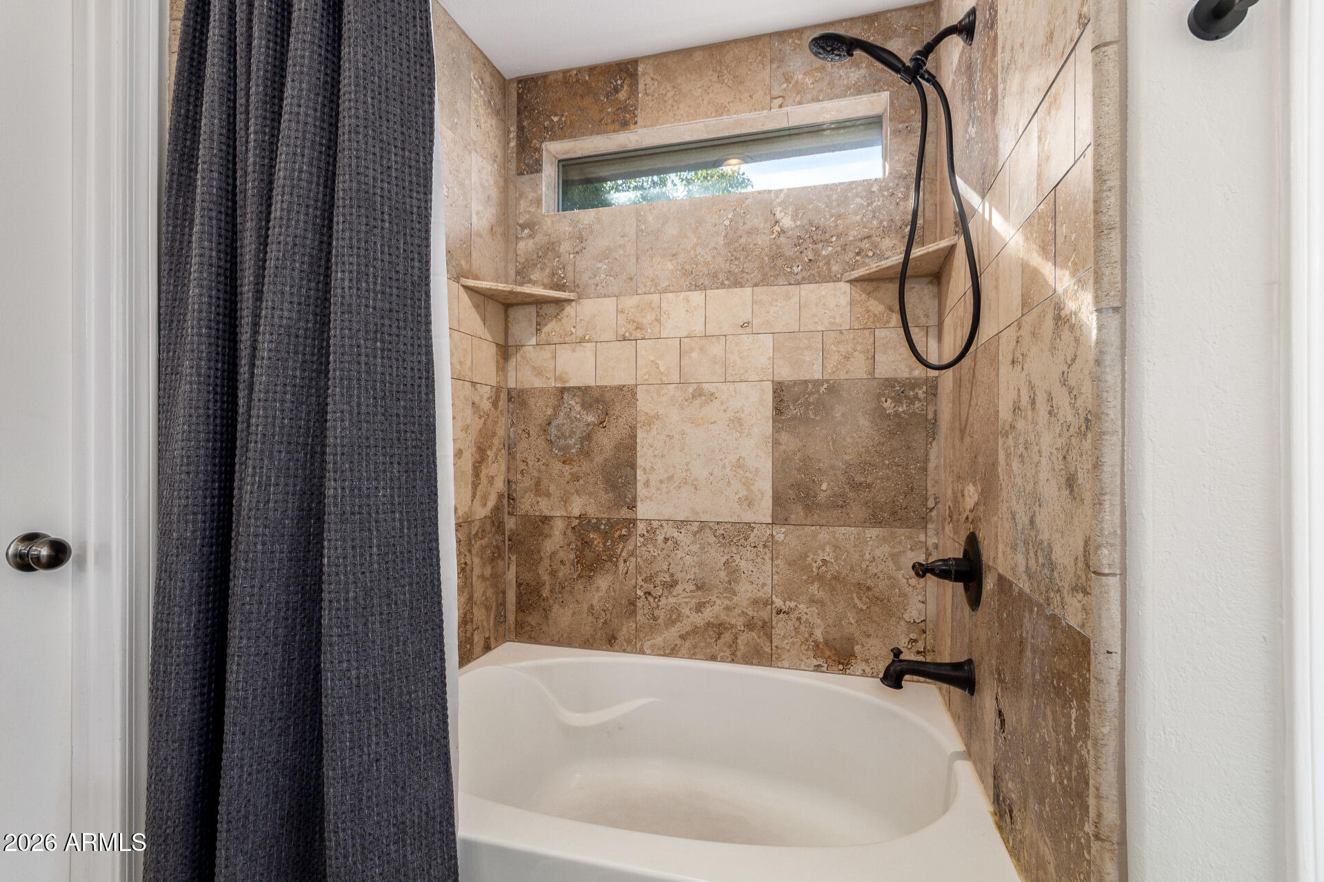 1519 East Elgin Street Gilbert, AZ 85295 - Photo 19 of 36 a bathroom with a glass shower door