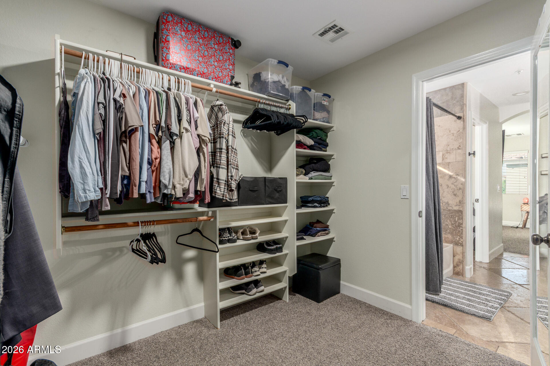 1519 East Elgin Street Gilbert, AZ 85295 - Photo 21 of 36 a view of walk in closet with clothes and shoes