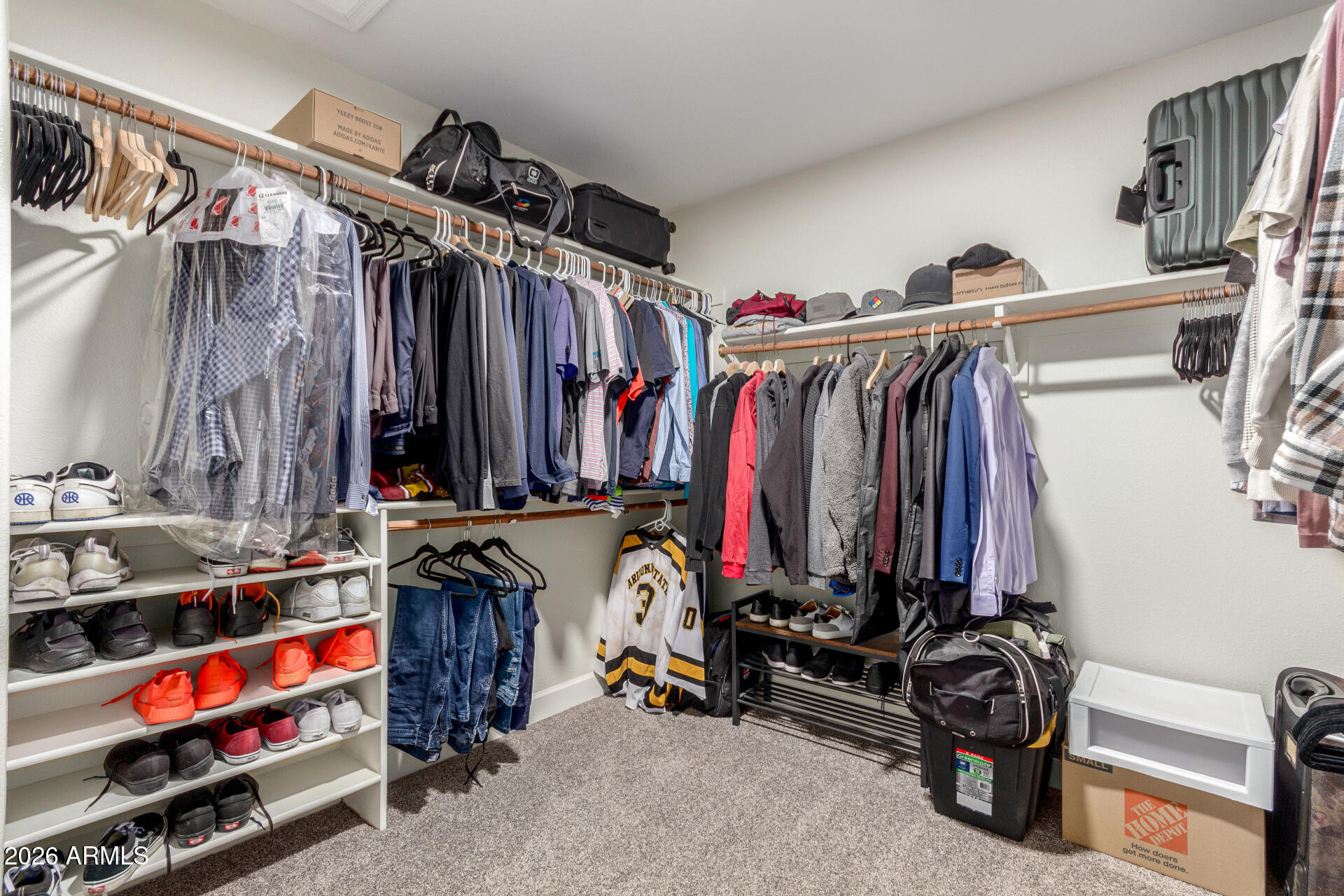 1519 East Elgin Street Gilbert, AZ 85295 - Photo 22 of 36 a view of walk in closet with clothes and shoes