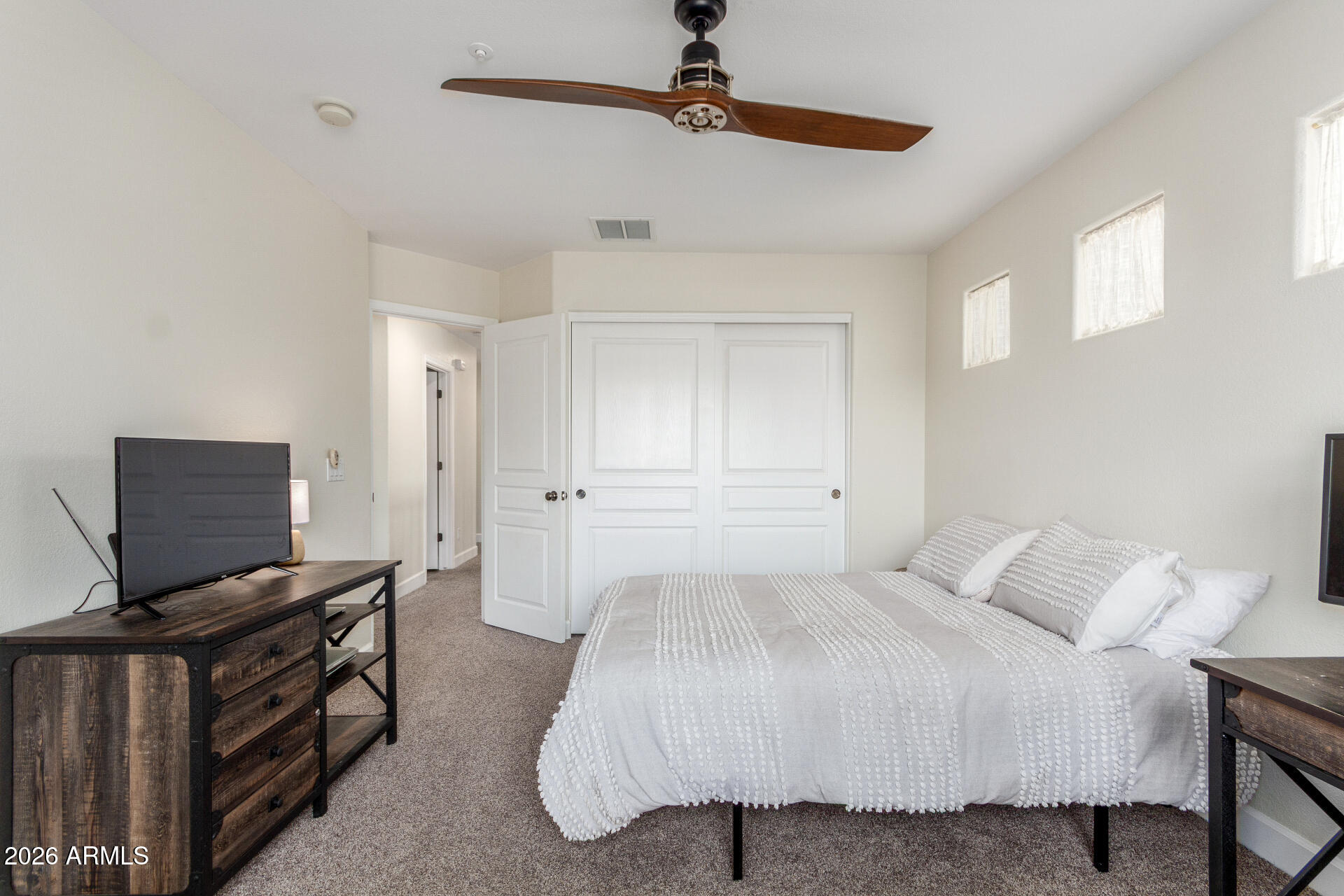 1519 East Elgin Street Gilbert, AZ 85295 - Photo 26 of 36 a bedroom with a bed and a flat tv screen
