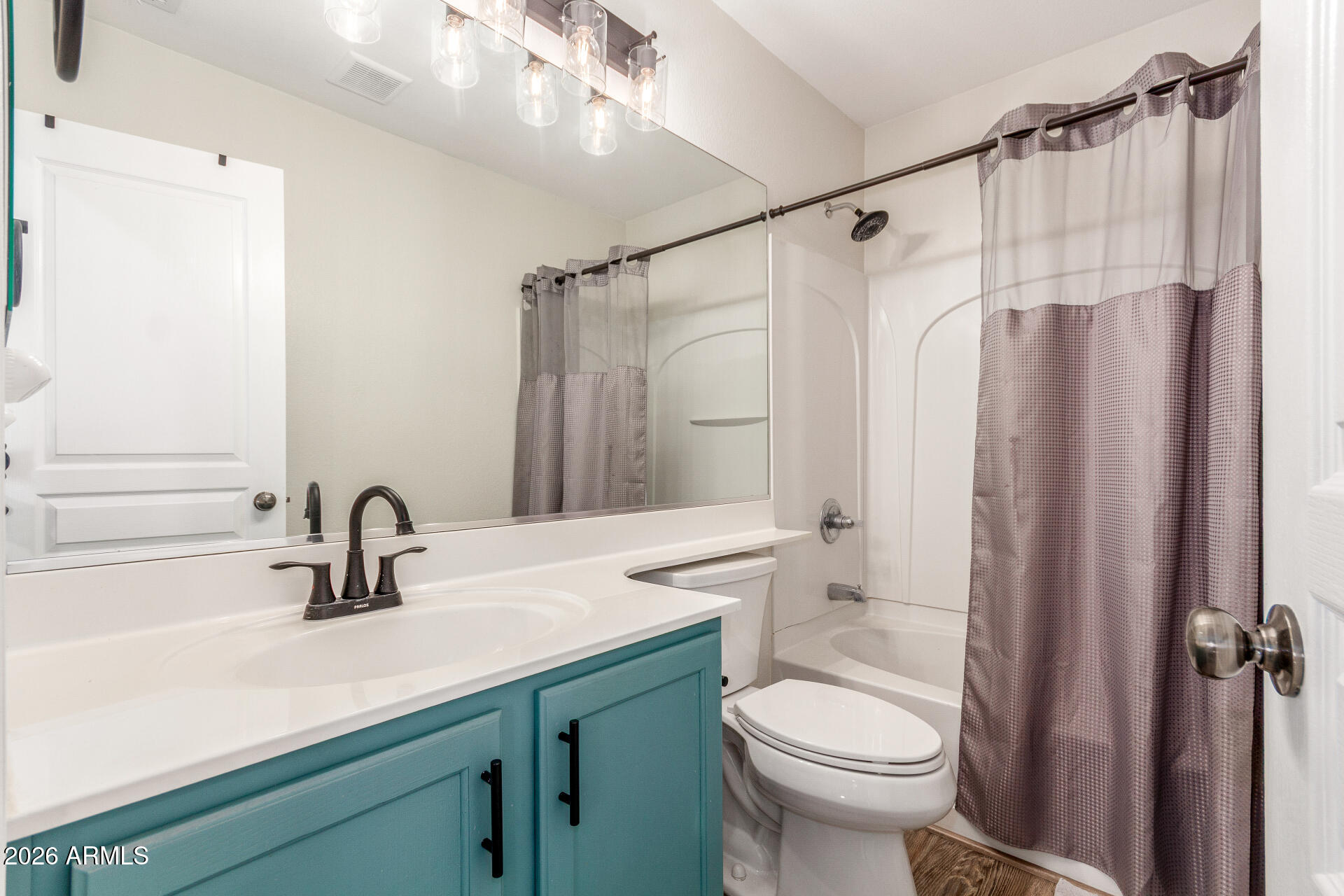 1519 East Elgin Street Gilbert, AZ 85295 - Photo 27 of 36 a bathroom with a sink a toilet a mirror and shower