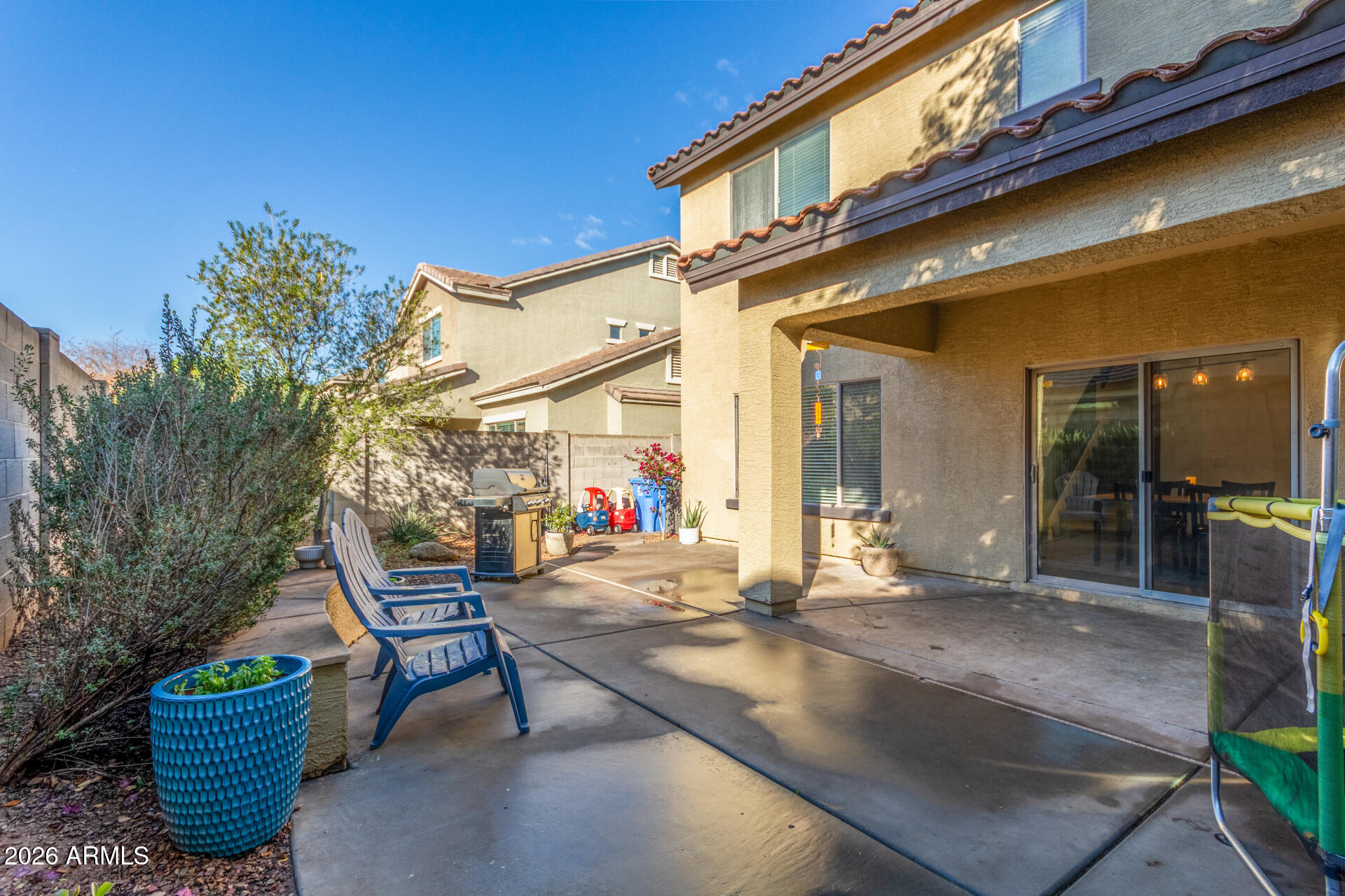 1519 East Elgin Street Gilbert, AZ 85295 - Photo 35 of 36 a patio with a table and chairs and potted plants