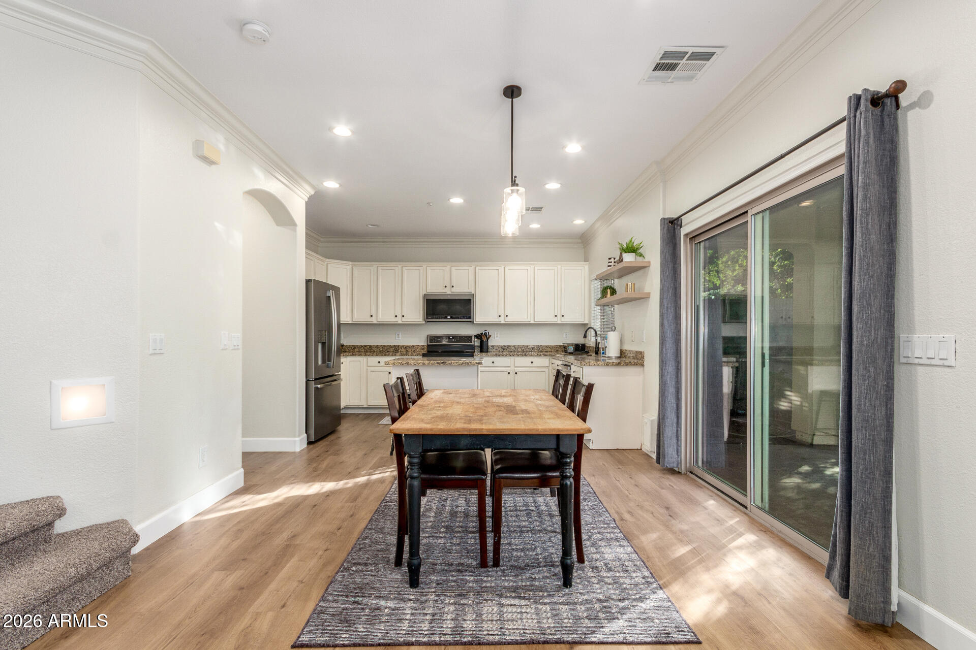 1519 East Elgin Street Gilbert, AZ 85295 - Photo 7 of 36 a kitchen with stainless steel appliances kitchen island granite countertop a refrigerator and a stove top oven
