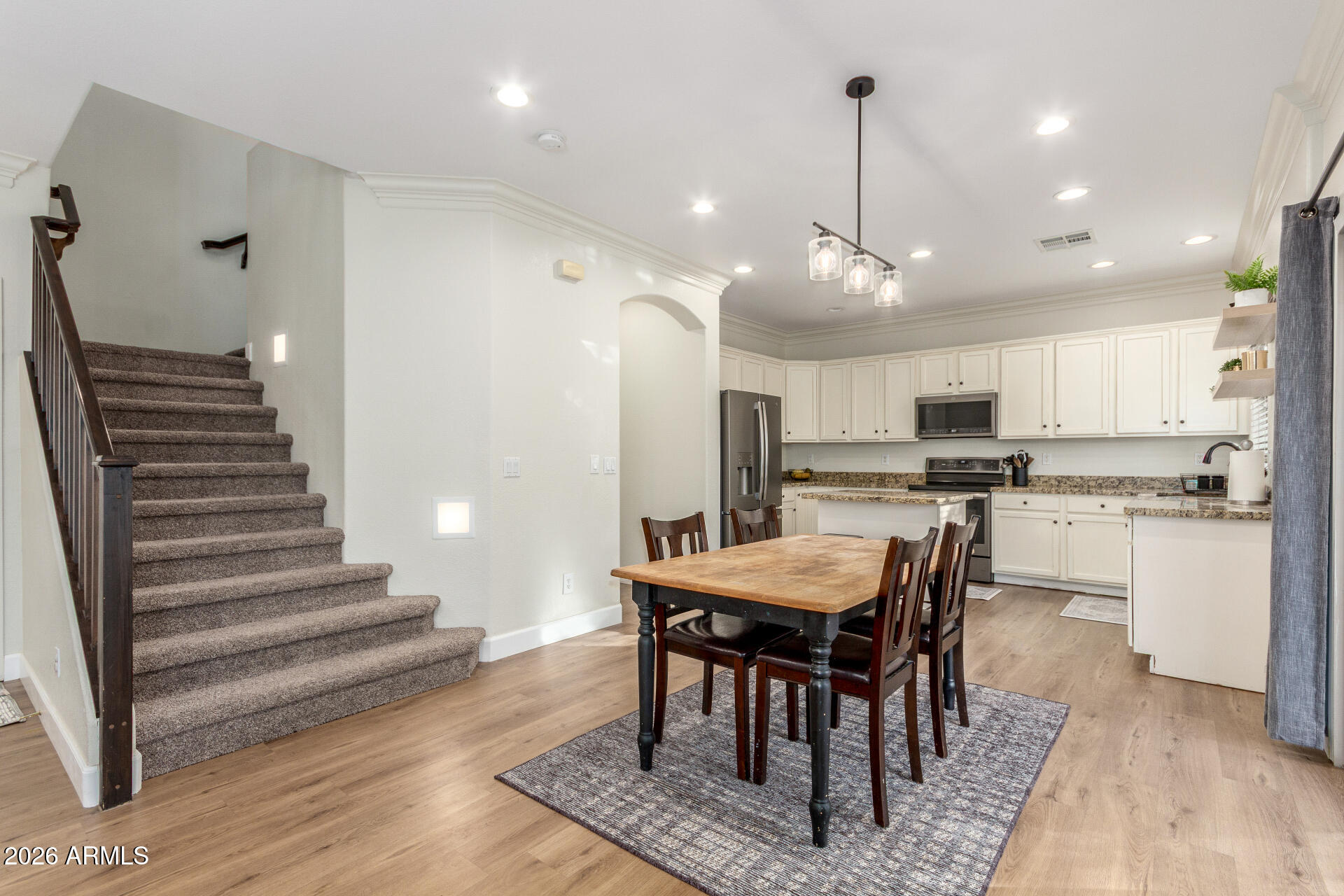 1519 East Elgin Street Gilbert, AZ 85295 - Photo 8 of 36 a view of a dining room with furniture and wooden floor