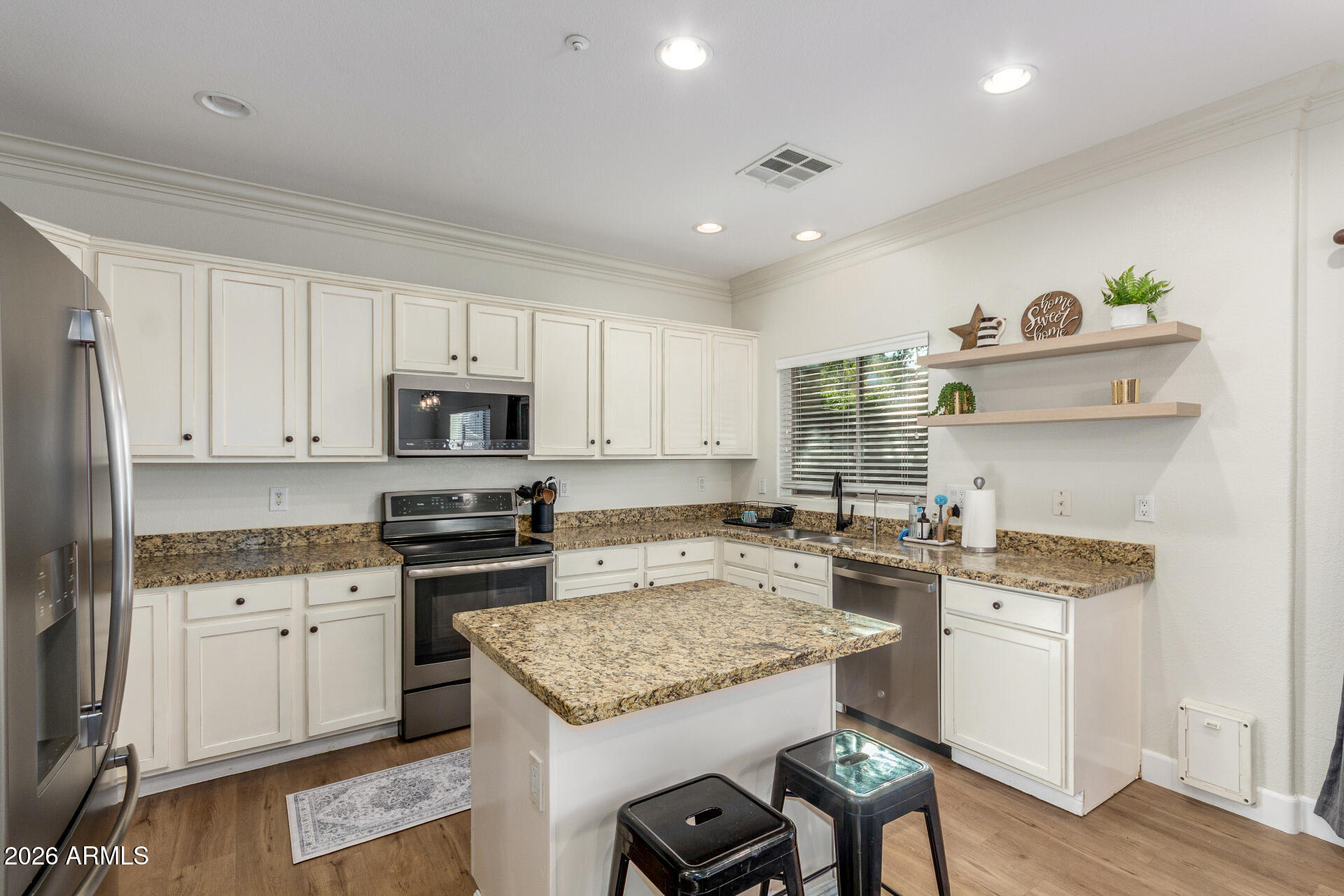 1519 East Elgin Street Gilbert, AZ 85295 - Photo 9 of 36 a kitchen with a stove a sink and a refrigerator