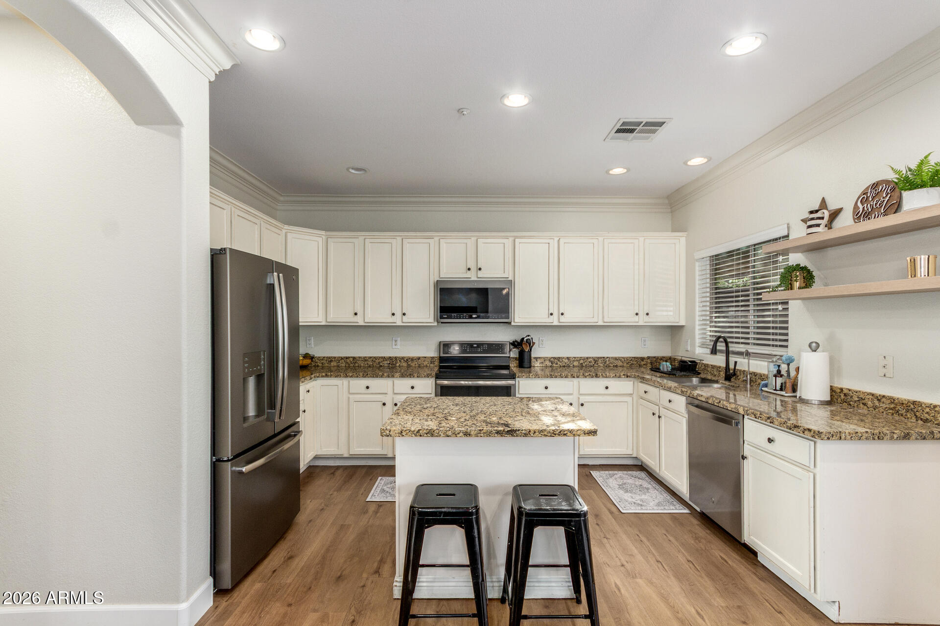 1519 East Elgin Street Gilbert, AZ 85295 - Photo 10 of 36 a kitchen with stainless steel appliances granite countertop a stove refrigerator sink and cabinets