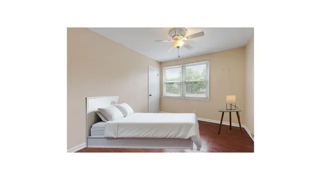 a living room with a bed furniture and a window