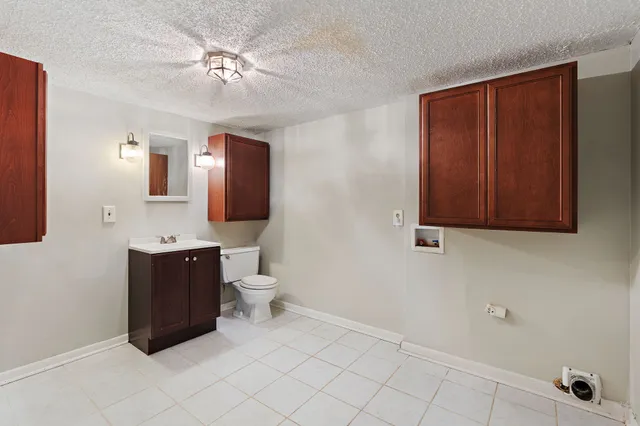 a living room with a cabinet and a mirror