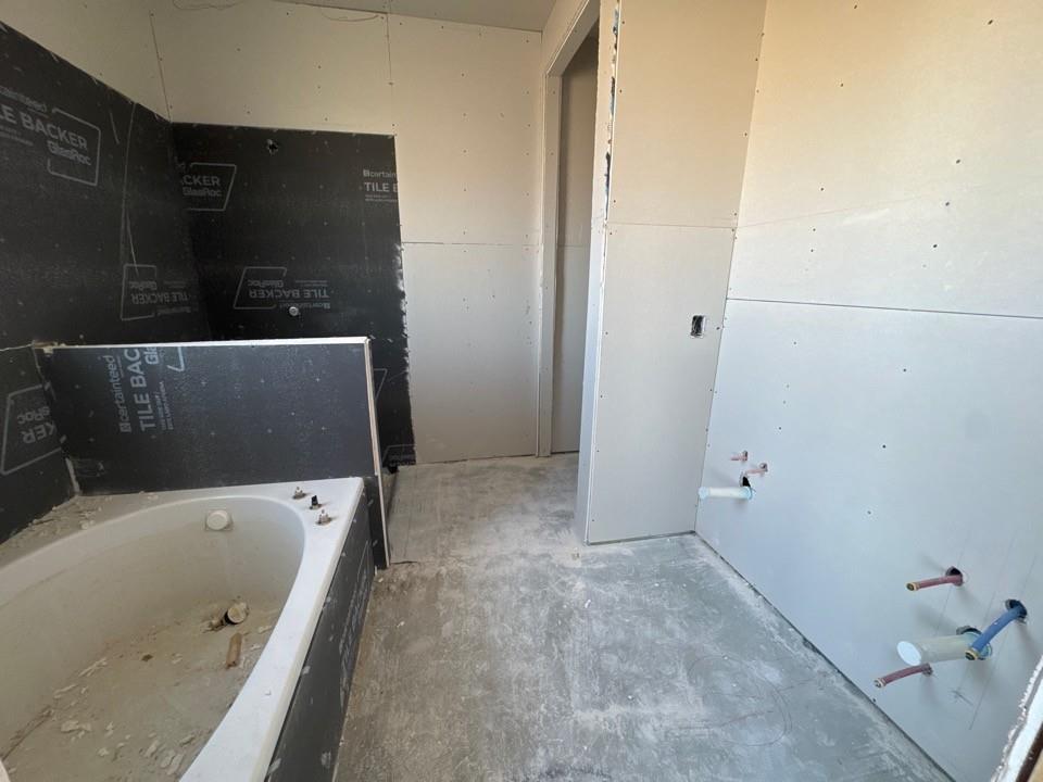 154 Snowy Owl Trail Rhome, TX 76078 - Photo 11 of 13 a bathroom with a bathtub and shower
