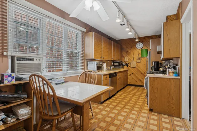 a spacious bedroom with a bed dresser and a window
