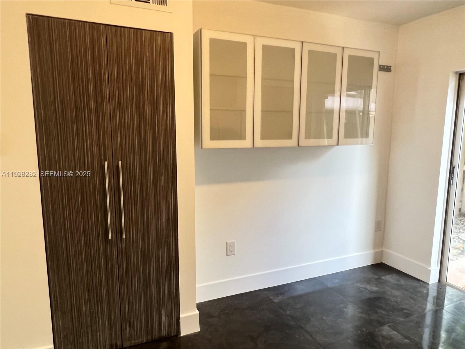 13120 Southwest 64th Terrace, Unit 1507 Miami, FL 33183 - Photo 4 of 6 an empty room with wooden floor and windows