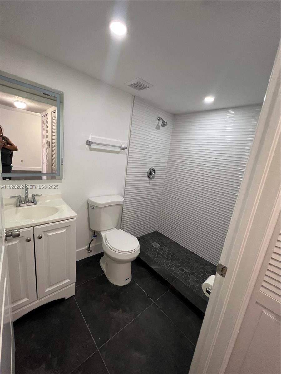 13120 Southwest 64th Terrace, Unit 1507 Miami, FL 33183 - Photo 6 of 6 a bathroom with a toilet sink and mirror