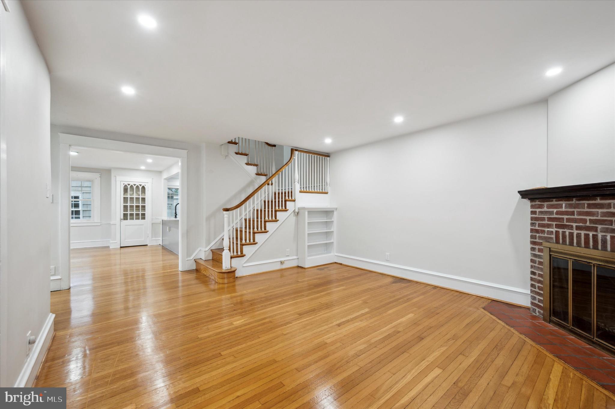 124 Walsh Road Lansdowne, PA 19050 - Photo 7 of 30 a view of empty room with wooden floor and fireplace