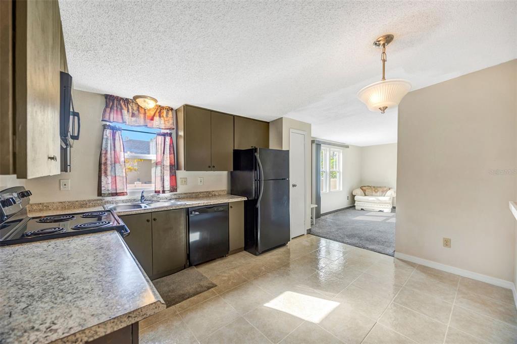 15615 Willowdale Road Tampa, FL 33625 - Photo 19 of 39 a kitchen with stainless steel appliances granite countertop a refrigerator and a sink