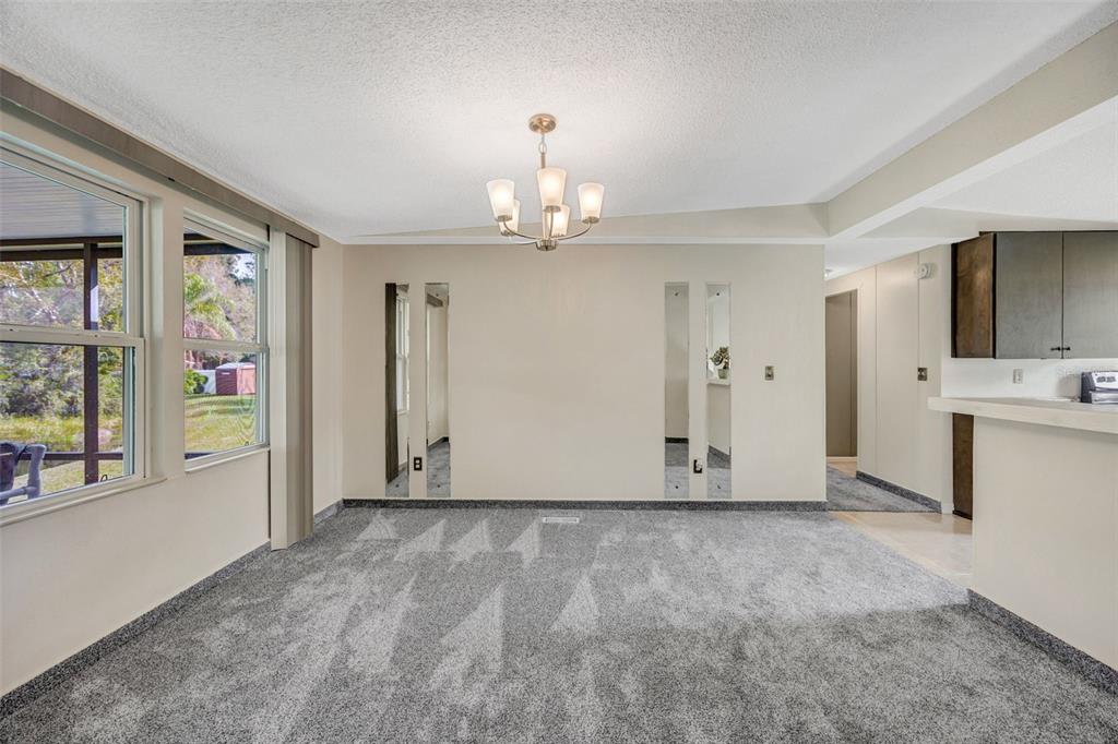 15615 Willowdale Road Tampa, FL 33625 - Photo 22 of 39 a view of an empty room with window and cabinet