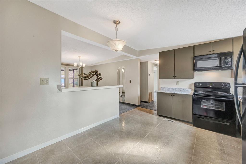 15615 Willowdale Road Tampa, FL 33625 - Photo 24 of 39 a kitchen with stainless steel appliances a refrigerator and a stove top oven