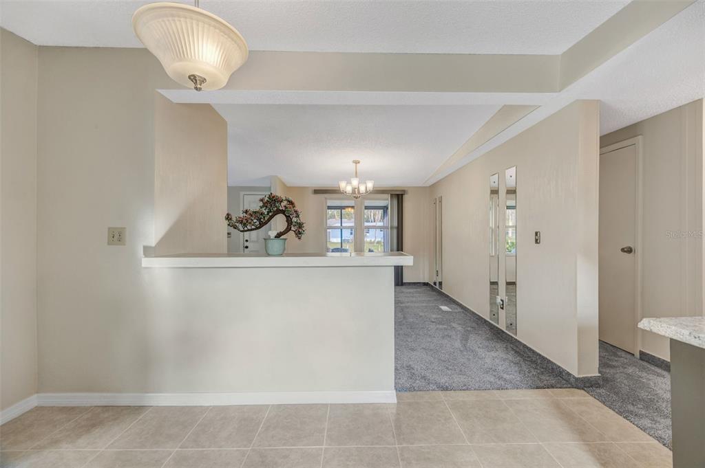 15615 Willowdale Road Tampa, FL 33625 - Photo 25 of 39 a view of a hallway with closet and a chandelier