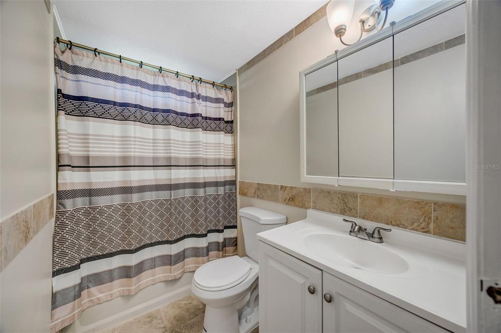15615 Willowdale Road Tampa, FL 33625 - Photo 26 of 39 a bathroom with a sink toilet and shower