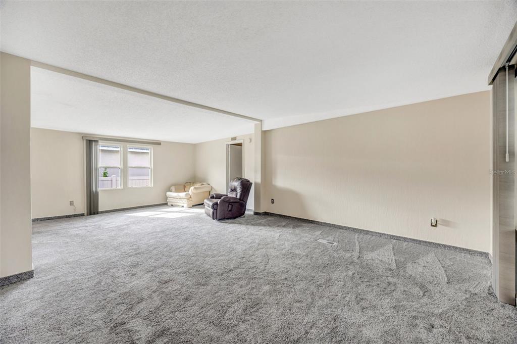 15615 Willowdale Road Tampa, FL 33625 - Photo 35 of 39 a big room with closet and a couch