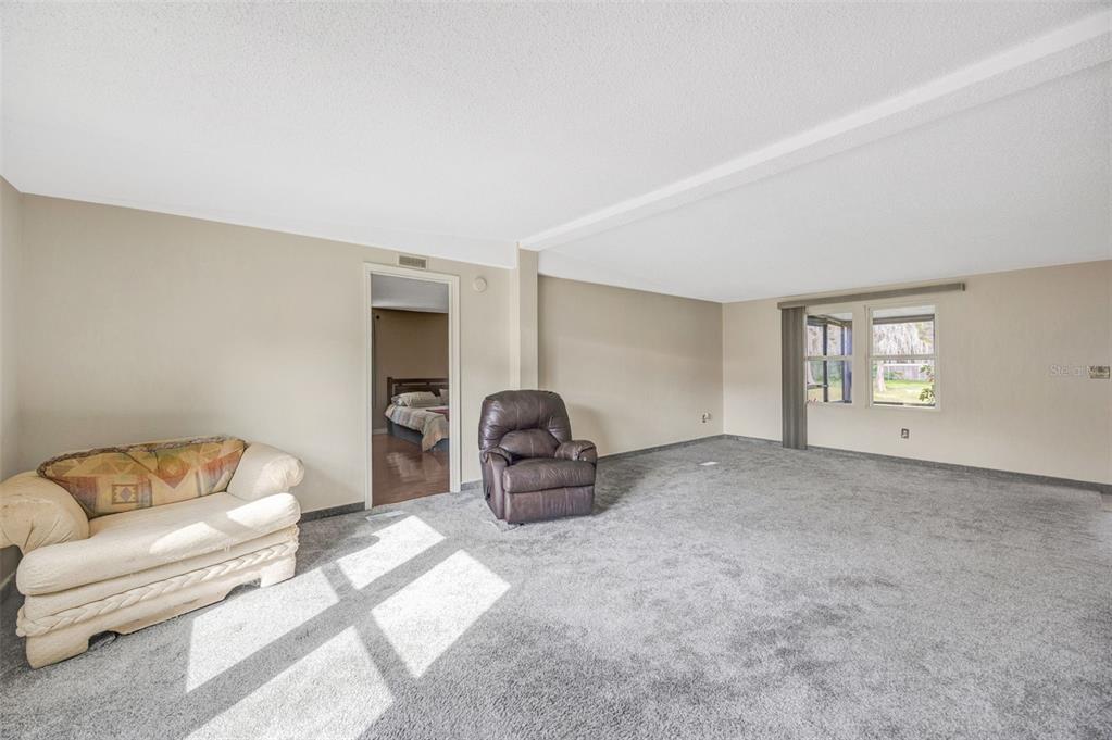 15615 Willowdale Road Tampa, FL 33625 - Photo 36 of 39 a living room with furniture a couch and a window