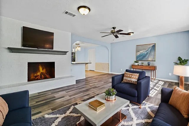 a view of a hallway with wooden floor and staircase