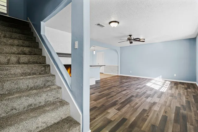a view of a room with wooden floor and windows