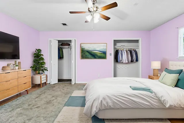 a bathroom with a granite countertop toilet sink and mirror