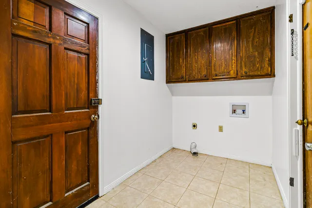 a large kitchen with stainless steel appliances a large counter top and a refrigerator